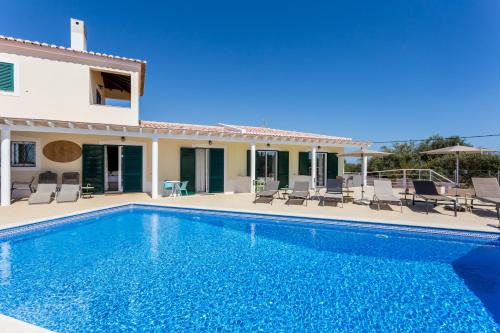 a villa with a swimming pool and a house at The Sun Hill in Lagos