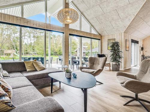 a living room with a couch and chairs and a table at 20 person holiday home in Frederiksværk in Frederiksværk