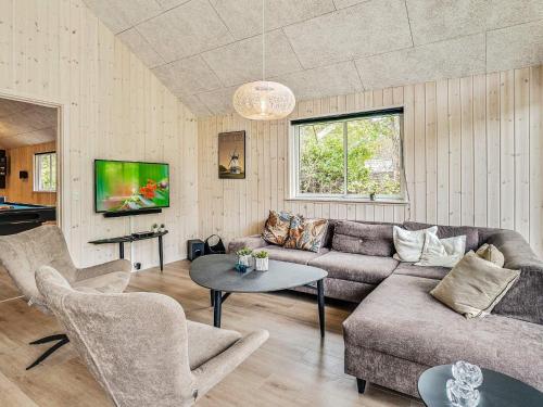 a living room with a couch and a table at 20 person holiday home in Frederiksværk in Frederiksværk