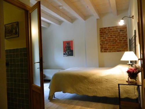 a bedroom with a bed and a bathroom at Agriturismo Cascina Pezzolo in Lodi