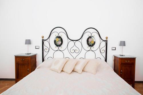 a bedroom with a white bed with two night stands at Domus Festina Lente in Orvieto