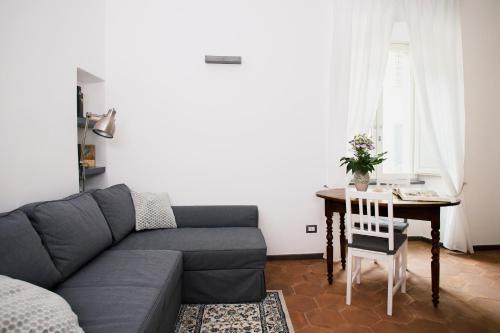 ein Wohnzimmer mit einem Sofa und einem Tisch in der Unterkunft Domus Festina Lente in Orvieto