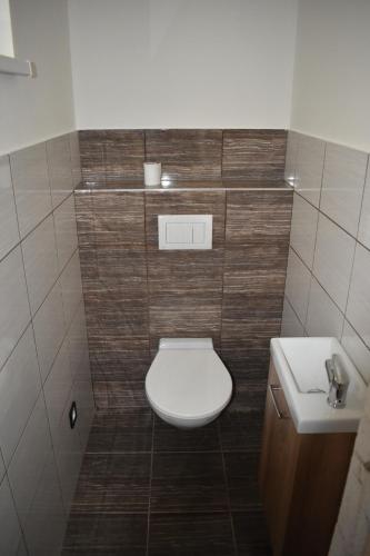 a bathroom with a toilet and a sink at Relax Morava in Velké Bílovice