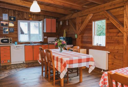 a kitchen and dining room with a table and chairs at Agroturystyka Pod Modrzewiami in Nowy Tomyśl