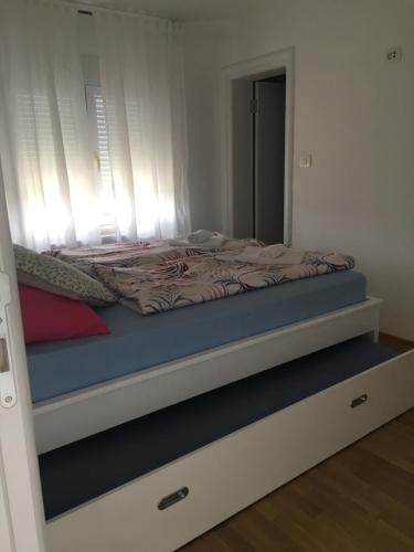 a bedroom with a bed with a mirror on it at Apartment Doma in Međugorje