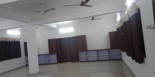 a room with wooden stalls and a ceiling fan at Anand Agro Tourism Kashid in Alibaug