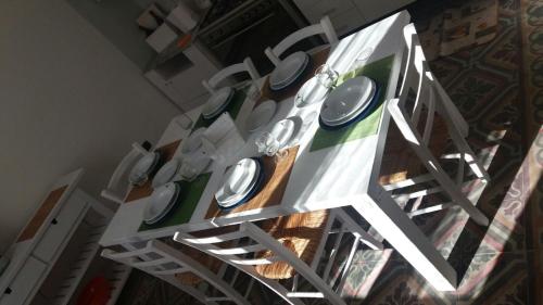 a white table with white plates on it at Casa Vacanze La Villa in Morino