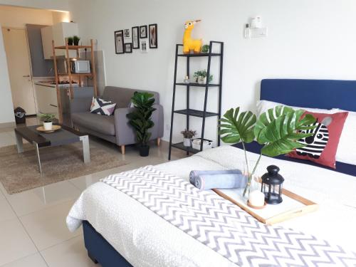 a bedroom with a bed and a living room at Galleria Equine Park @ Seri Kembangan in Seri Kembangan