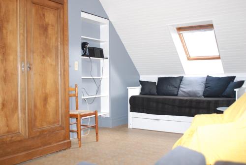 ein Wohnzimmer mit einem Sofa und einem Fenster in der Unterkunft Studio le Sterne in Perros-Guirec