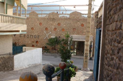 a building with a sign on the side of a street at Hotel Leonor in Had Beni Chiker