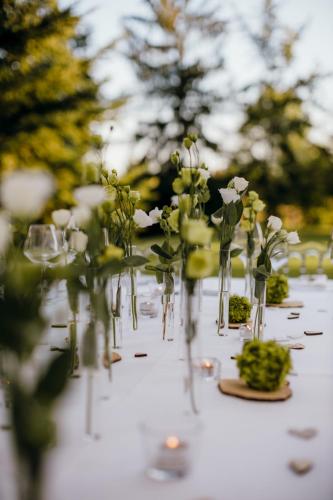 a table with vases filled with flowers on it at Albergo Ristorante Belvedere in Tricesimo