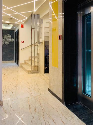 a lobby with marble floors and stairs in a building at City Empire New Delhi Train Station in New Delhi