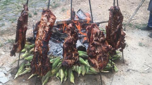 a bunch of food being cooked on a grill at APARTAHOTEL TAYAMBE in La Mesa