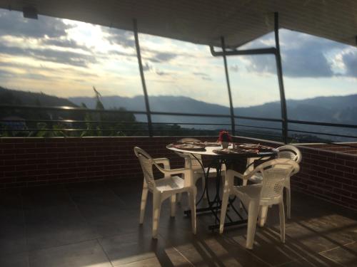 a table and chairs on a balcony with a view at APARTAHOTEL TAYAMBE in La Mesa