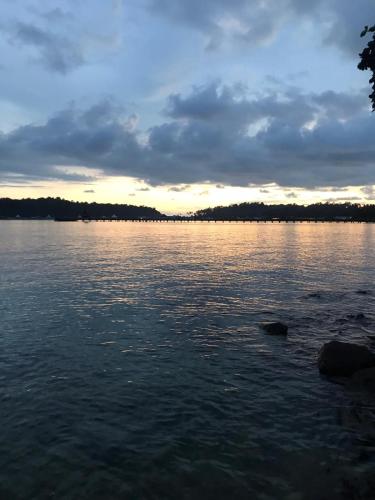 a view of a large body of water at sunset at Secret Garden Family House in Ko Chang