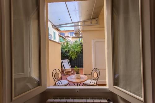 a window view of a balcony with a table and chairs at Datini Apartment in Prato