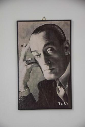 a framed picture of a man smoking a cigarette at Hotel Kennedy in Naples
