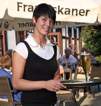 a woman standing in front of a table with a trophy at Halberstädter Hof in Halberstadt