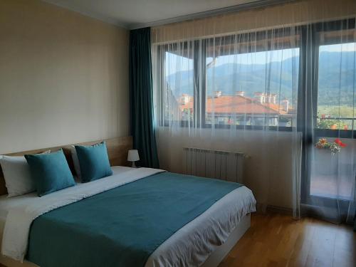 a bedroom with a large bed with a large window at Studio- apartament Lake View Pravets Spa and Golf Resort in Pravets