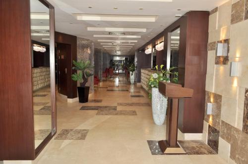 a hallway of a building with plants and a hallway sidx sidx sidx at Golden Park Hotel Cairo, Heliopolis in Cairo