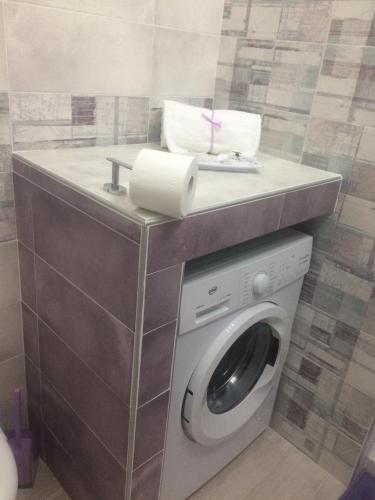 a washing machine in a bathroom with a counter at Casa Violet per Civita in Bagnoregio