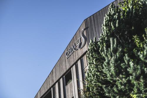 a building with a sign on the side of it at Hotel Chalet S - Dolomites Design - adults recommended in Selva di Val Gardena