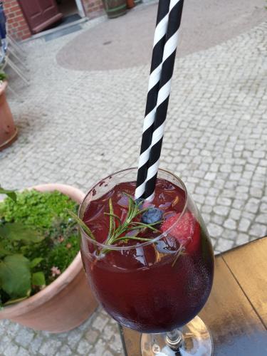 a drink with a black and white striped straw at Gwuni Mopera in Leipzig