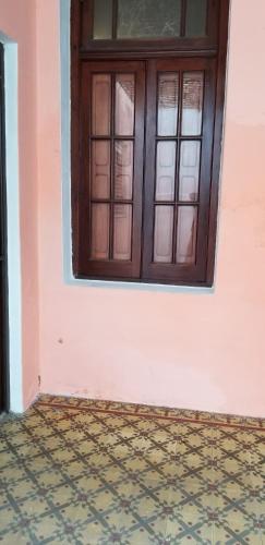 a room with a window and a tiled floor at Hotel Caballito Blanco in Santa Fe