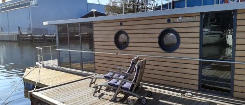 a chair sitting on a dock next to a boat at La Mare Resort in Gothenburg