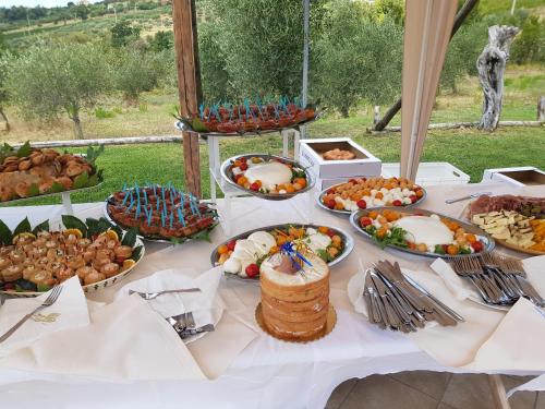 a table topped with lots of different types of food at L' Aia Resort in Trentinara