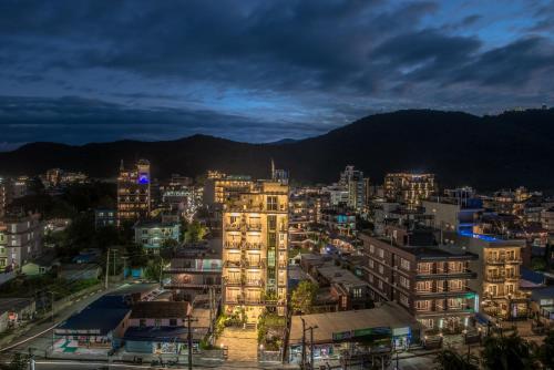 a city lit up at night with buildings at Hotel Haven O' Ganga in Pokhara