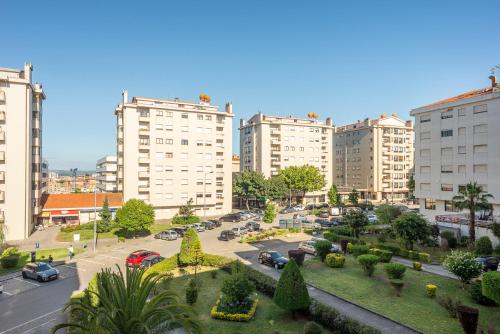 a city with tall buildings and a parking lot with cars at Gaia Center Near Porto in Vila Nova de Gaia