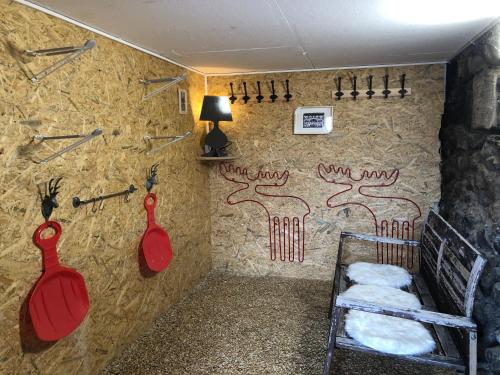 a room with a wall with two red paddles on it at Chalet Rouge Coeur in Fenalet Sur Bex