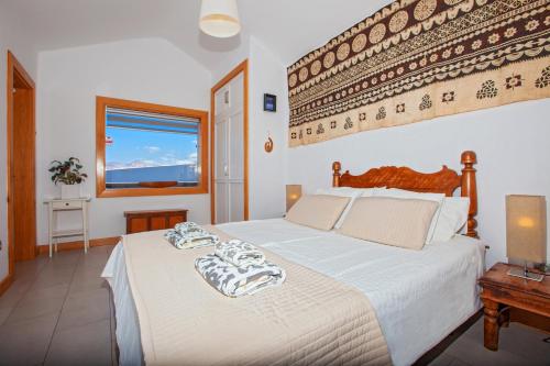 a bedroom with a bed and a window at Villa Luna Mar - Magnificent Sea Views - Private Pool - Hot Tub in Puerto Calero