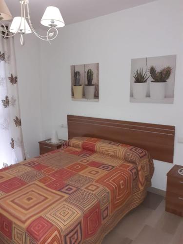 a bedroom with a bed with a colorful bedspread at 29 Calle Cártama in La Cala de Mijas