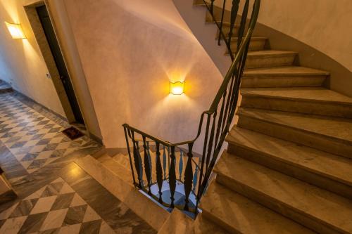 a staircase in a building with a light on the wall at L'angolo di Luccoli in Genova