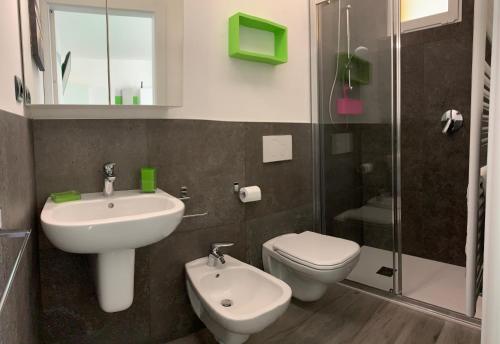 a bathroom with a sink and a toilet and a shower at Villa Lori Apartments Garden and Beach in Peschiera del Garda