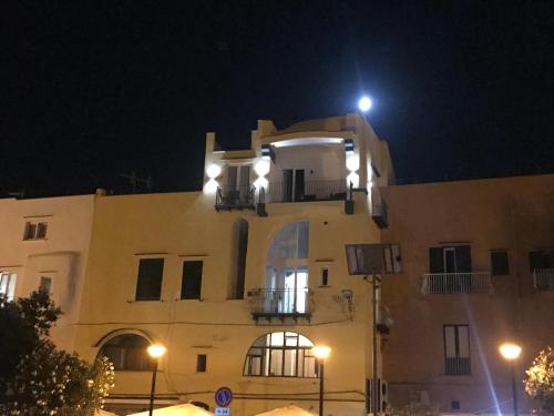 a building with a light on top of it at night at Vento di mare in Procida