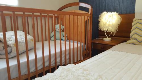 a baby crib with a teddy bear sitting in it at Porto In Sight, 4 Kids in Vila Nova de Gaia