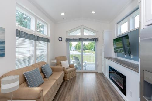 a living room with a couch and a fireplace at Sun Outdoors Petoskey Bay Harbor in Petoskey