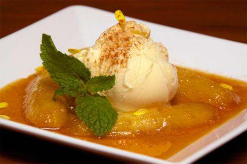 a dessert with a scoop of ice cream on a plate at Pousada Porto Mare in Maresias