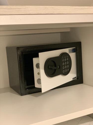 a black and white microwave oven on a shelf at Apart 31 in Cetinje