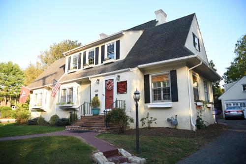 a white house with a flag in front of it at Blacksburg Bed & Breakfast in Blacksburg