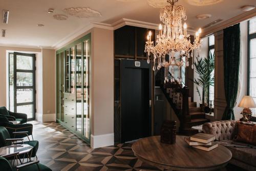 a living room with a chandelier and a table at 1930 Boutique Hotel in Arzúa