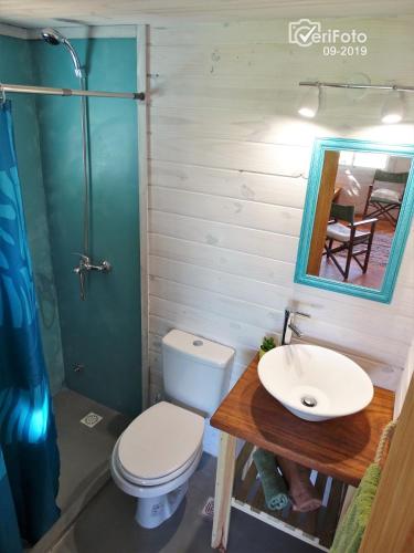 a bathroom with a toilet and a sink at Palapas al mar in Punta Del Diablo