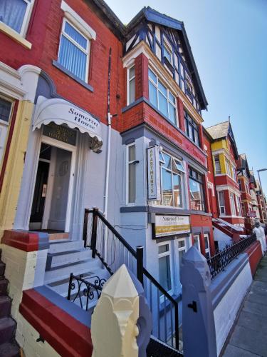 a row of colorful houses on a street at Somerset House Apartments in Blackpool
