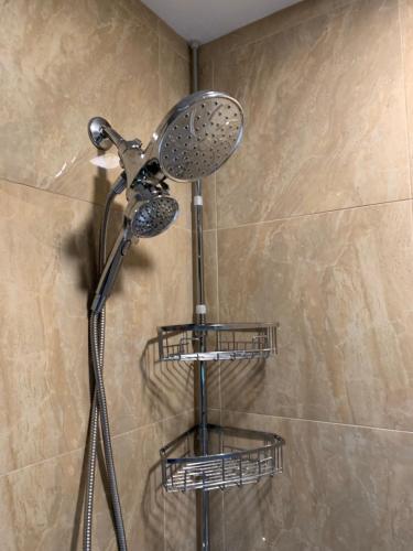 a shower with a shower head in a bathroom at Private Guest Bedroom - 2E East Room - Close to Lake Michigan in Sheboygan