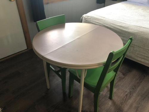 a table and two chairs in a room with a bed at Jasper Way Inn Resort & Campground in Clearwater
