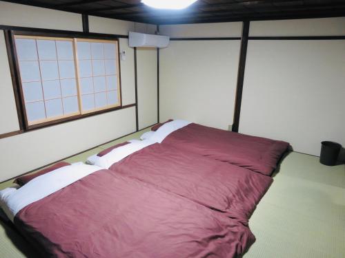Una cama o camas en una habitación de Utatei Nada