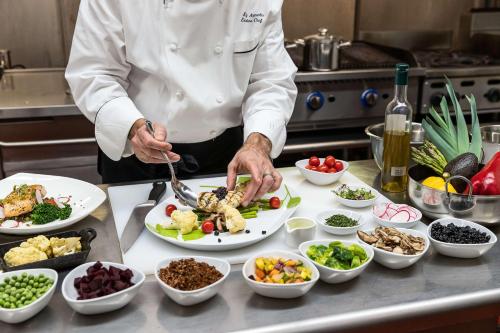 a chef preparing food on a counter in a kitchen at Hyatt Regency Boston in Boston